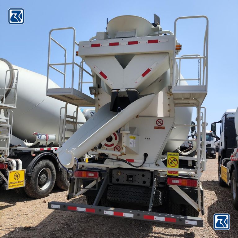 Close-up of the rear unloading mechanism of a HOWO concrete mixer truck before cleaning
